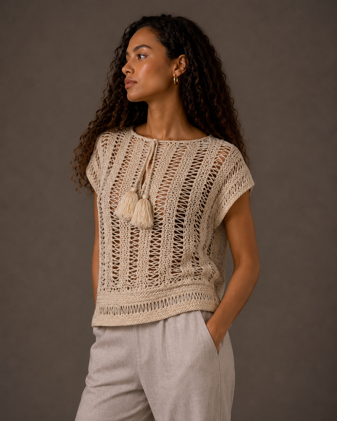 Cream top with tassels and adjustable drawstring collar. s-m-l