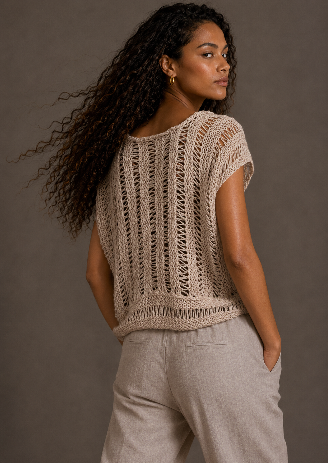 Cream top with tassels and adjustable drawstring collar. s-m-l