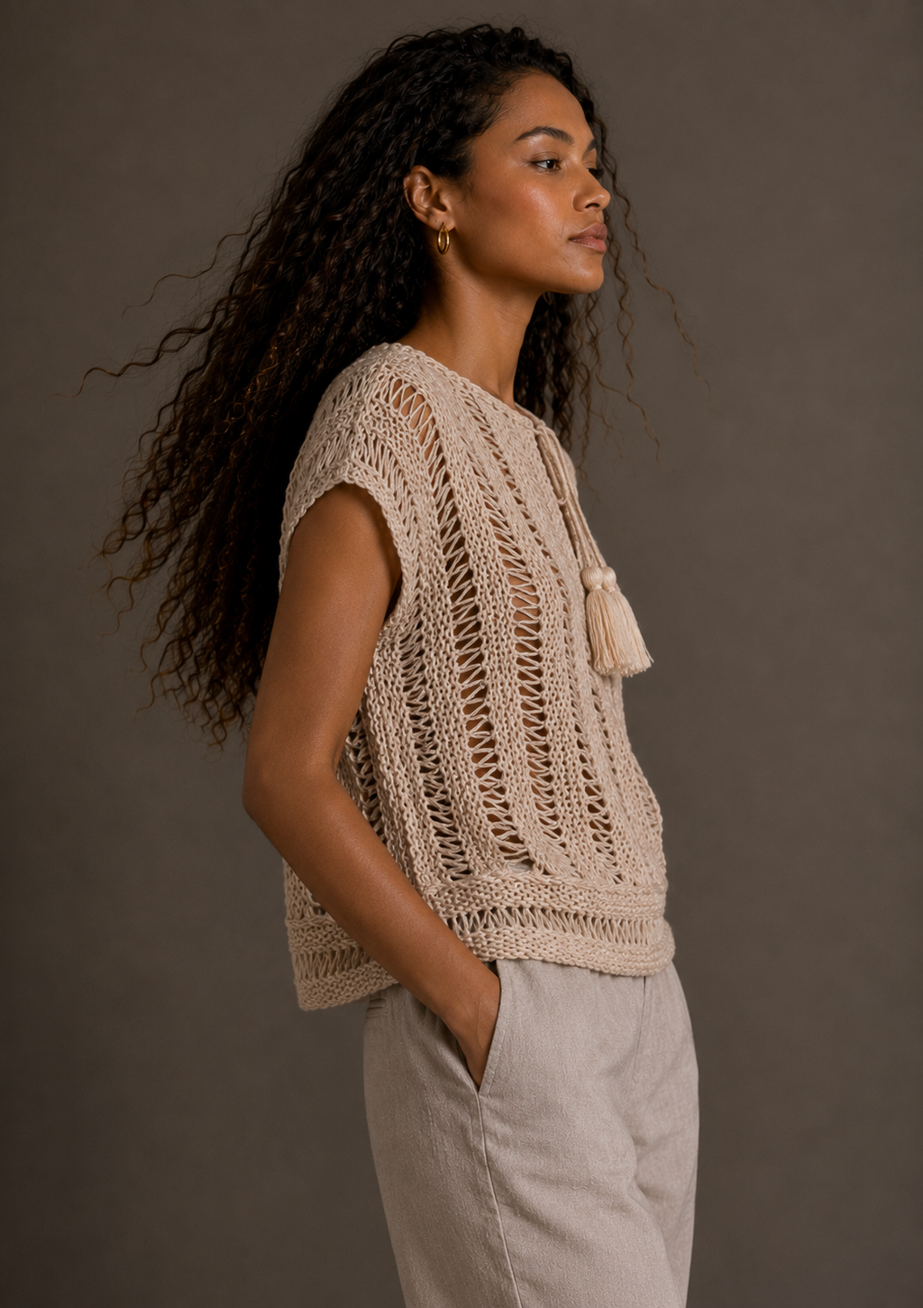 Cream top with tassels and adjustable drawstring collar. s-m-l
