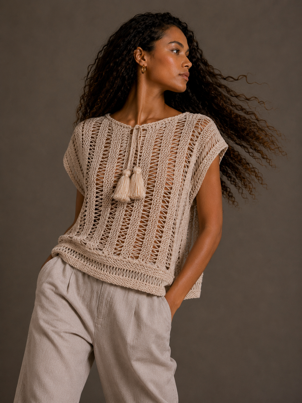 Cream top with tassels and adjustable drawstring collar. s-m-l