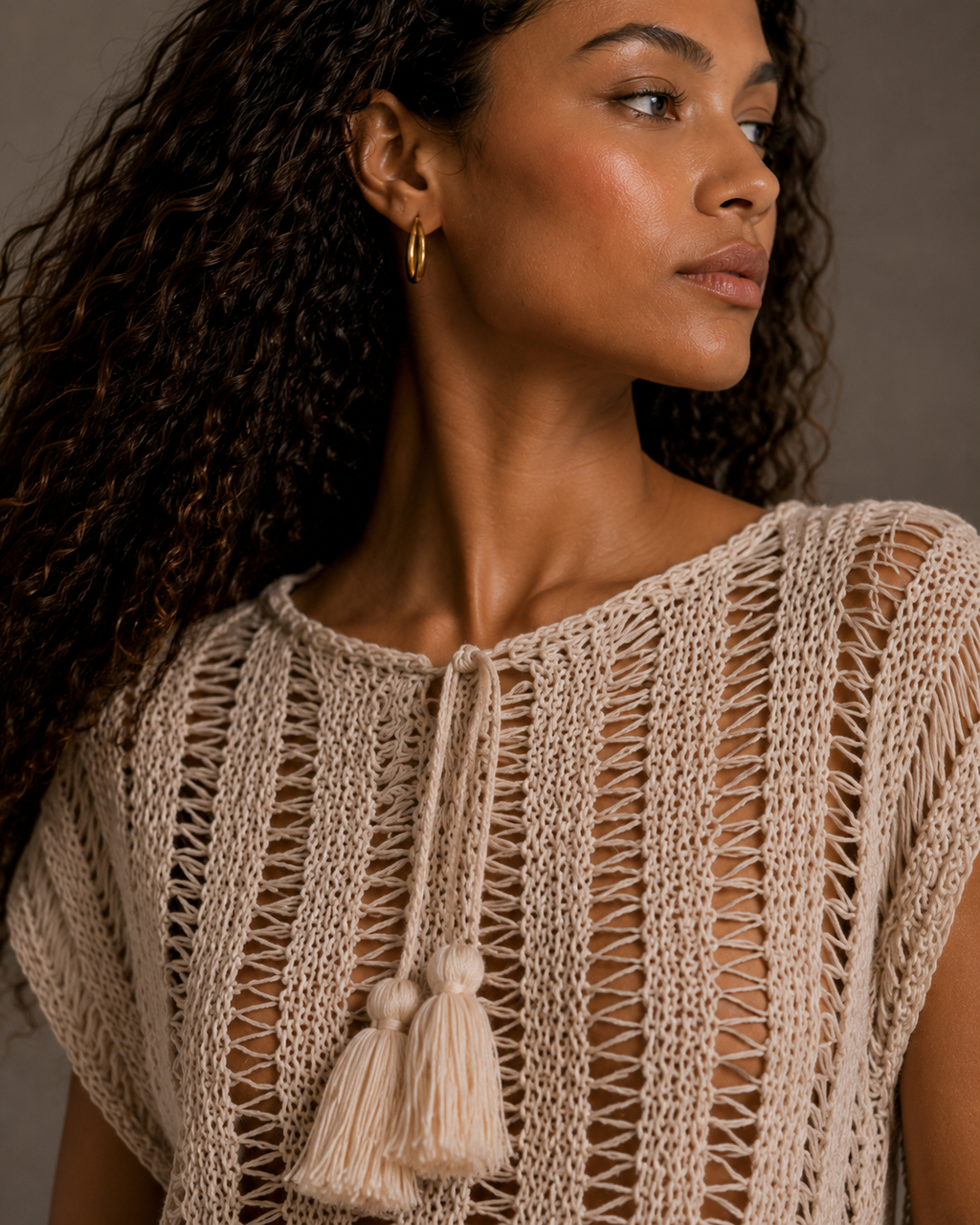 Cream top with tassels and adjustable drawstring collar. s-m-l